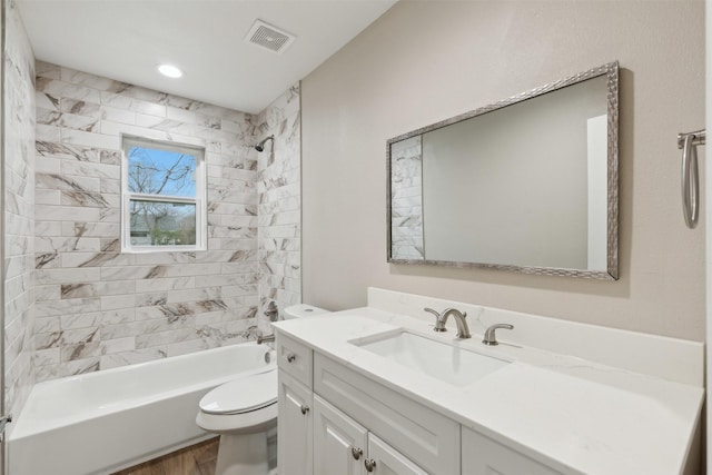 full bath with bathing tub / shower combination, visible vents, toilet, vanity, and wood finished floors