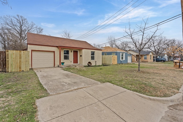 view of front of house with driveway, a residential view, an attached garage, fence, and a front lawn