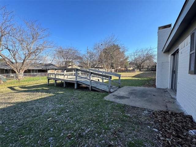 view of yard with a patio and a wooden deck