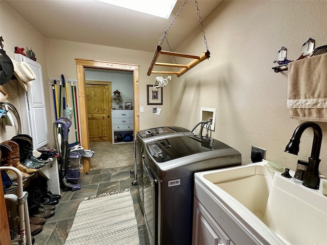 laundry area with independent washer and dryer and sink