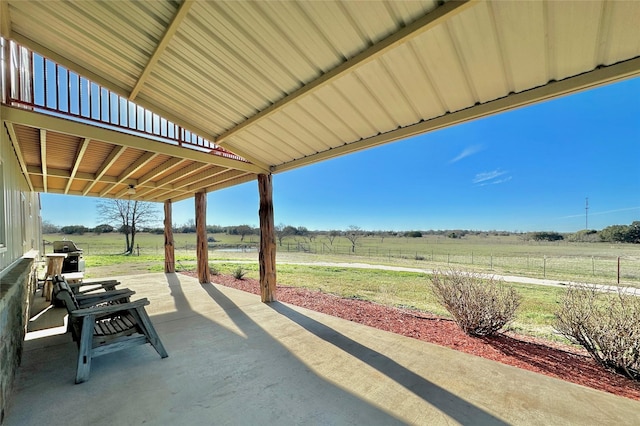 view of patio with a rural view and area for grilling