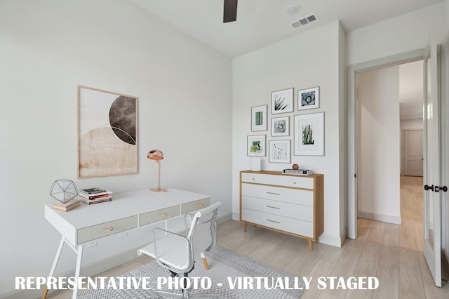 office with light wood-type flooring and ceiling fan