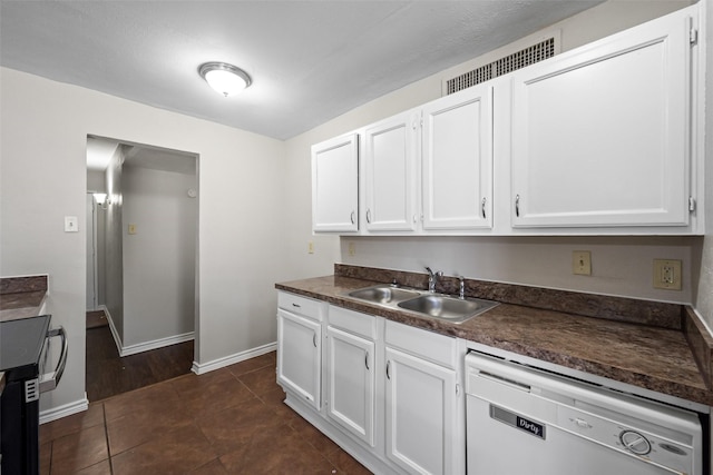 kitchen with sink, white cabinetry, dark tile patterned flooring, and dishwasher