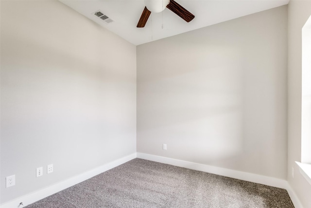 carpeted spare room with ceiling fan