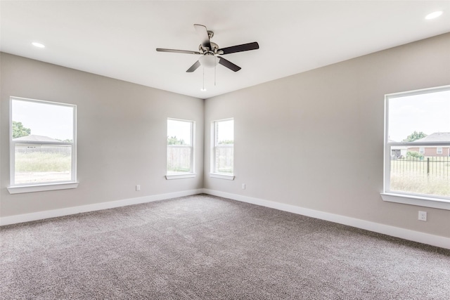 carpeted spare room with ceiling fan