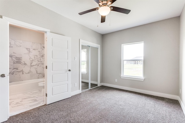 unfurnished bedroom with multiple windows, a closet, and carpet floors