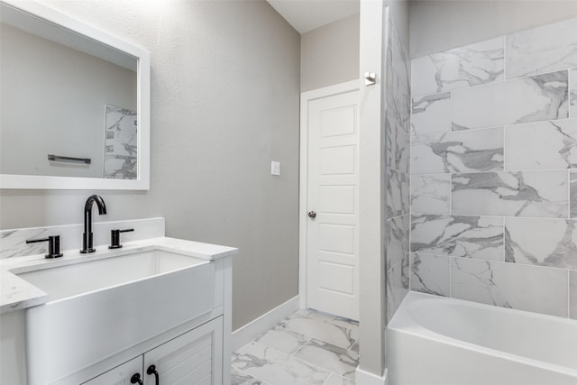 bathroom featuring vanity and tiled shower / bath