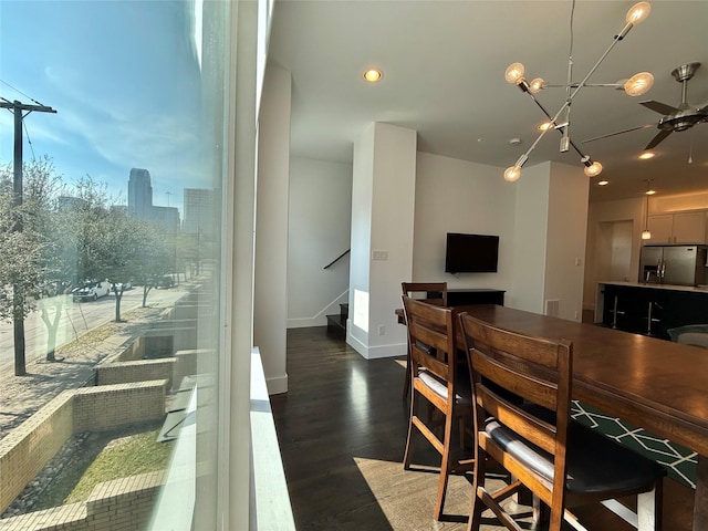 dining area featuring ceiling fan and dark hardwood / wood-style flooring