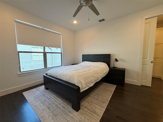 bedroom with ceiling fan and dark hardwood / wood-style floors