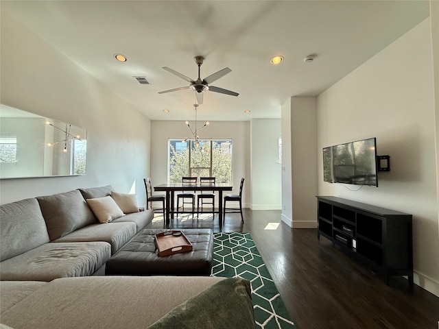 living room with ceiling fan and dark hardwood / wood-style floors