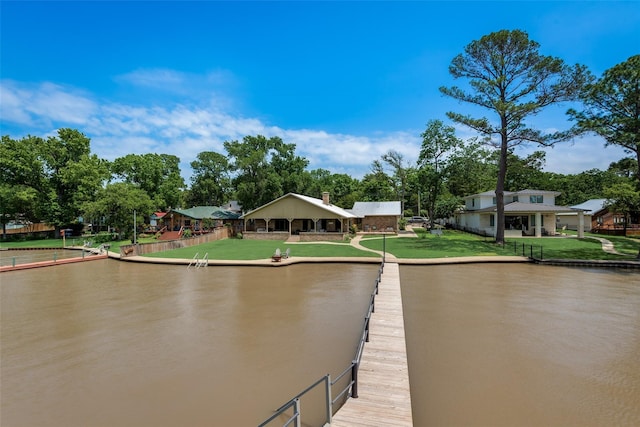 dock area featuring a water view and a lawn