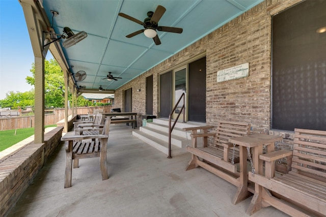 view of patio with ceiling fan and fence