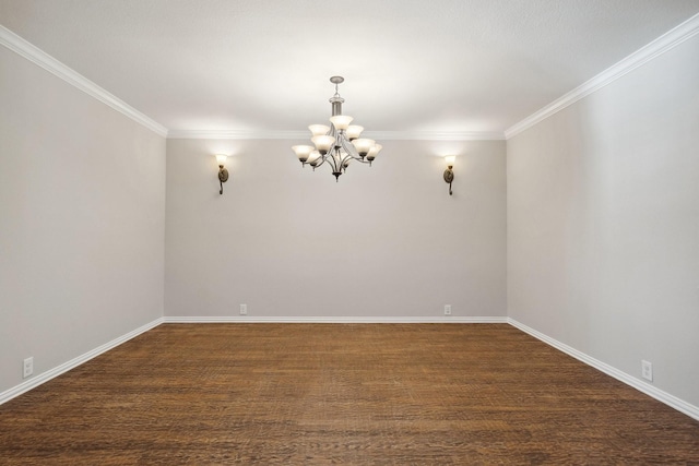 empty room featuring dark hardwood / wood-style floors, a notable chandelier, and ornamental molding