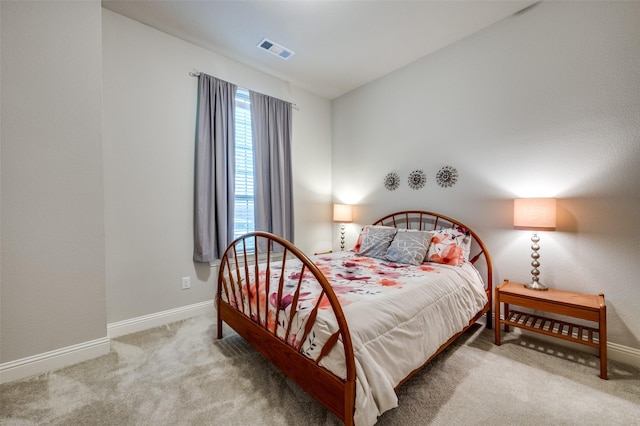 bedroom featuring lofted ceiling, visible vents, light carpet, and baseboards