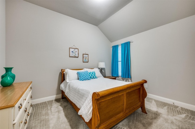 bedroom with carpet, baseboards, and vaulted ceiling