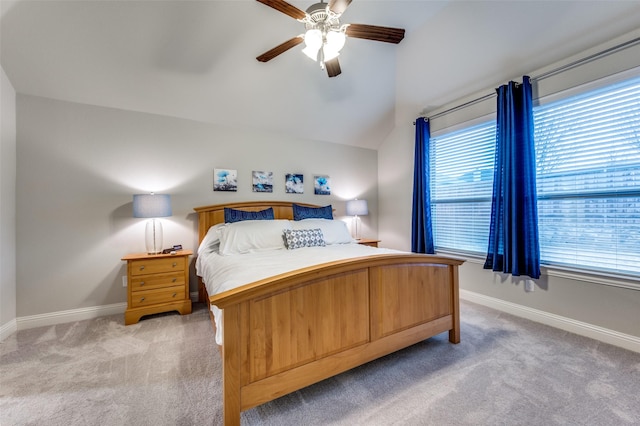 bedroom featuring light carpet, multiple windows, and baseboards