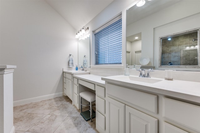 full bathroom with lofted ceiling, a sink, a shower stall, tile patterned floors, and double vanity