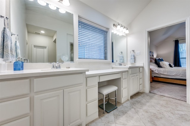 full bath featuring a sink, visible vents, vaulted ceiling, double vanity, and ensuite bath