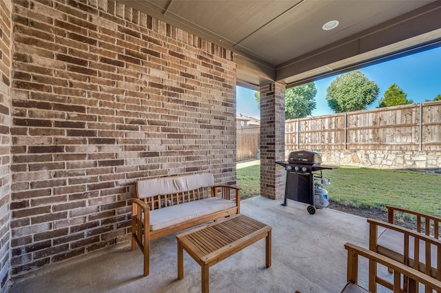 view of patio featuring fence and area for grilling