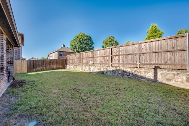 view of yard with a fenced backyard