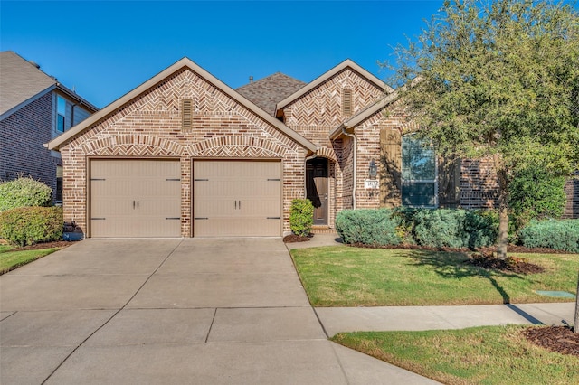 french country style house with concrete driveway, roof with shingles, an attached garage, a front lawn, and brick siding