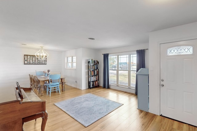 entryway featuring light hardwood / wood-style floors and a chandelier