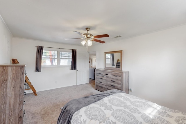 bedroom with ceiling fan, crown molding, and light colored carpet