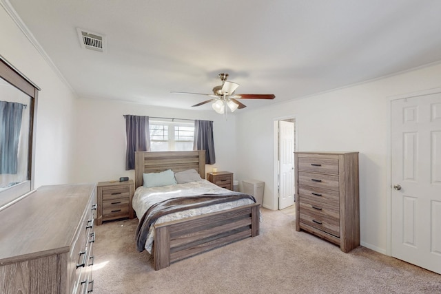 bedroom with ornamental molding, light colored carpet, and ceiling fan