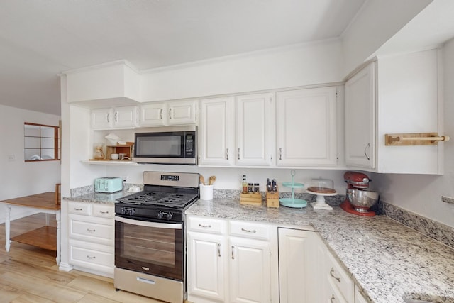 kitchen featuring light stone counters, light hardwood / wood-style floors, stainless steel appliances, crown molding, and white cabinets