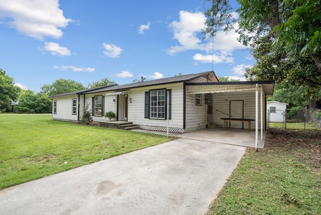 ranch-style home with a front yard and a carport