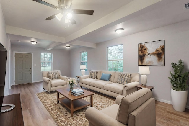 living room with beam ceiling, light hardwood / wood-style flooring, and ceiling fan