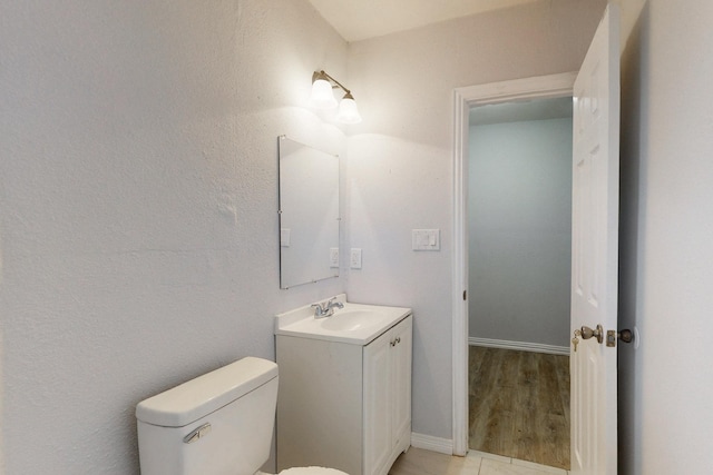 bathroom featuring toilet and vanity