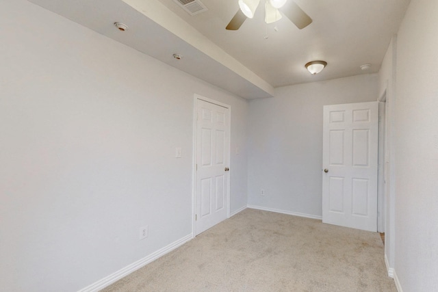 unfurnished room featuring ceiling fan and light colored carpet