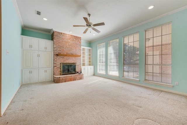 unfurnished living room with recessed lighting, visible vents, ornamental molding, a brick fireplace, and carpet