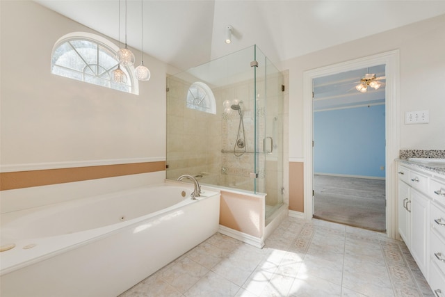 bathroom featuring a shower stall, baseboards, a bath, and vanity