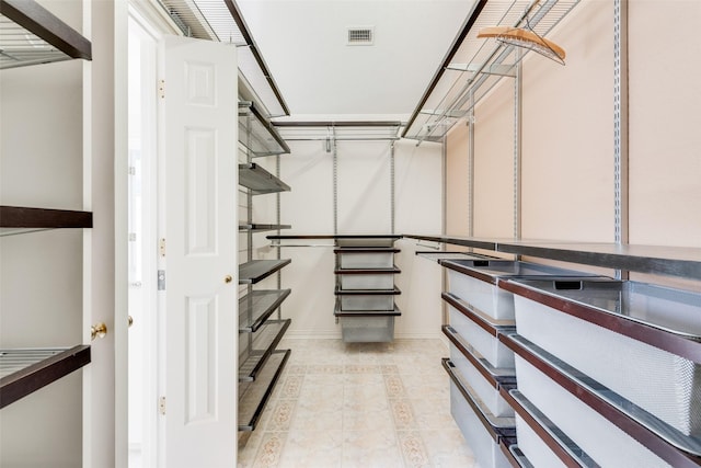 walk in closet with light tile patterned flooring and visible vents