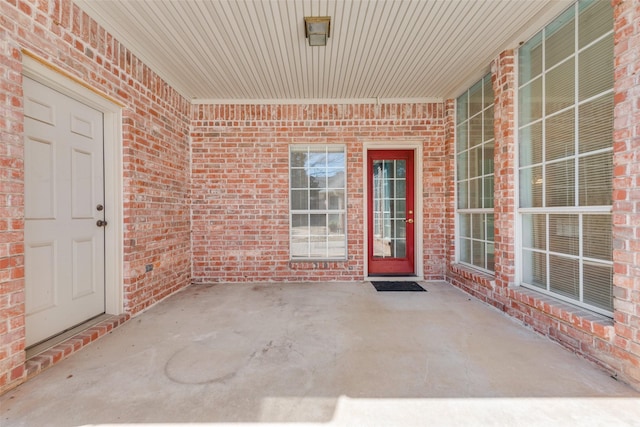 property entrance featuring brick siding