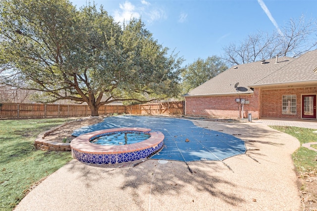 view of swimming pool with a patio area, a fenced backyard, a fenced in pool, and an in ground hot tub