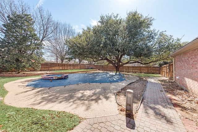 view of pool featuring an outdoor fire pit, a fenced backyard, and a patio