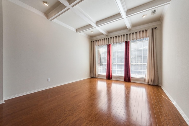 unfurnished room with beamed ceiling, coffered ceiling, hardwood / wood-style flooring, and baseboards