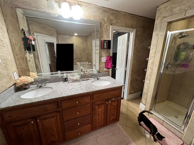 bathroom with tile patterned floors, a shower with shower door, and vanity