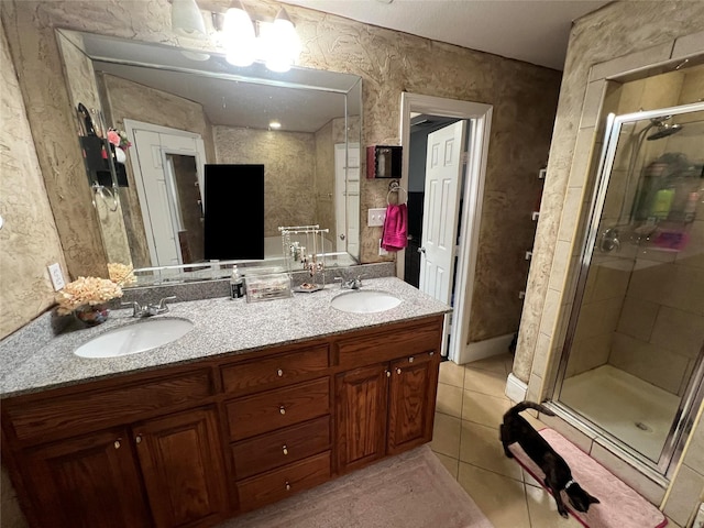 bathroom with walk in shower, tile patterned flooring, and vanity