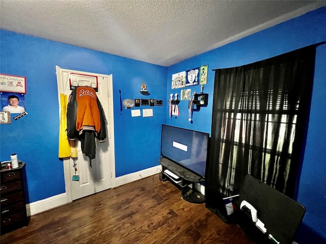 bedroom featuring a textured ceiling and hardwood / wood-style flooring