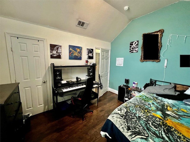 bedroom featuring lofted ceiling and dark hardwood / wood-style flooring