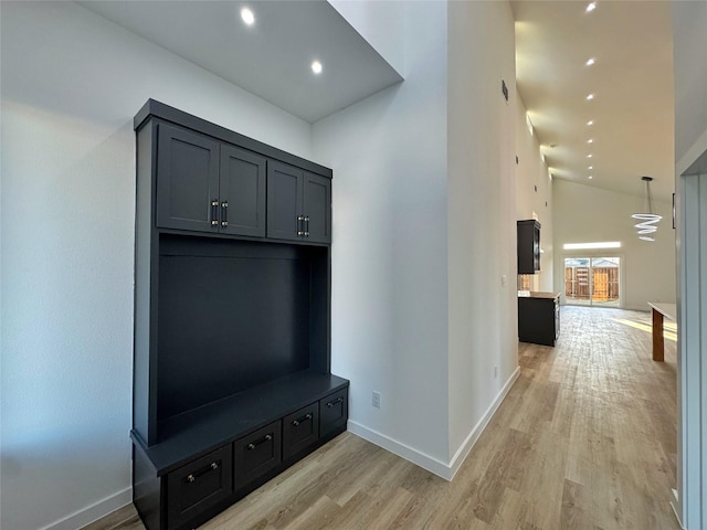 mudroom featuring high vaulted ceiling and light hardwood / wood-style flooring