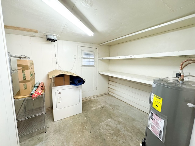 basement with water heater and washer / dryer