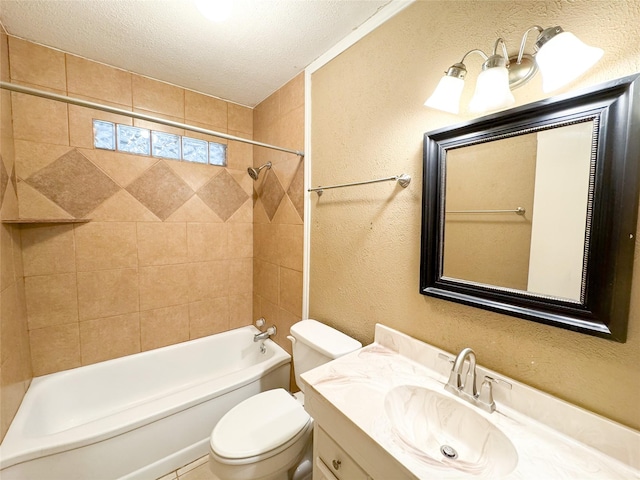 full bathroom with a textured ceiling, toilet, vanity, and tiled shower / bath