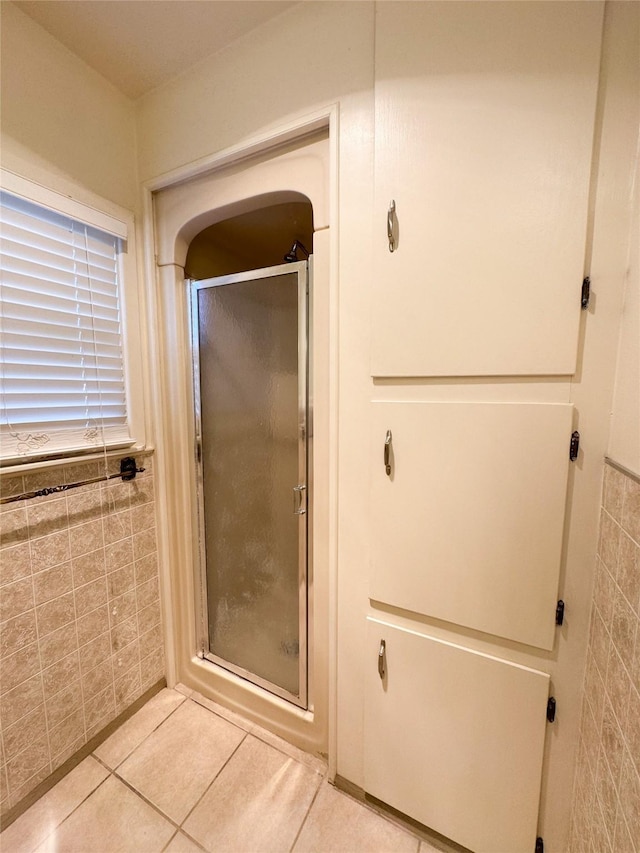 bathroom with tile walls and tile patterned floors