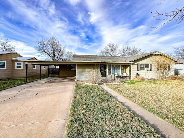 single story home with covered porch, a front yard, and a carport