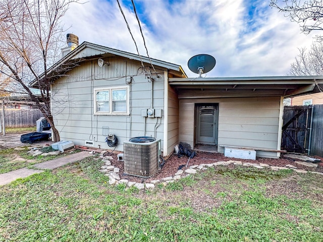 back of house with central AC unit